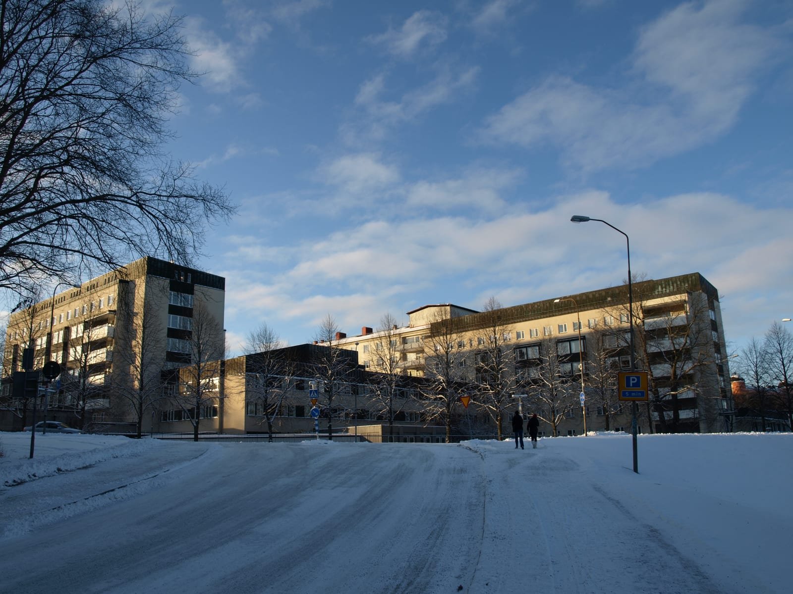 Winter view of Uppsala University Hospital buildings across a snowy road.